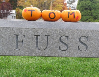 Three small pumpkins spelling TOM on the Fuss gravestone