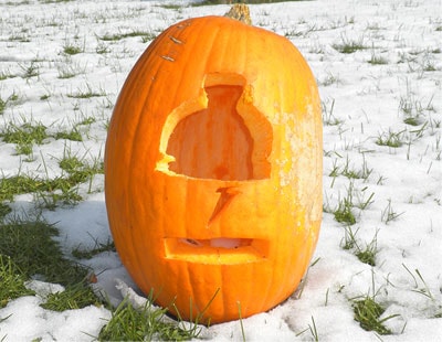 Pumpkin carved with a Gatorade bottle in the snow