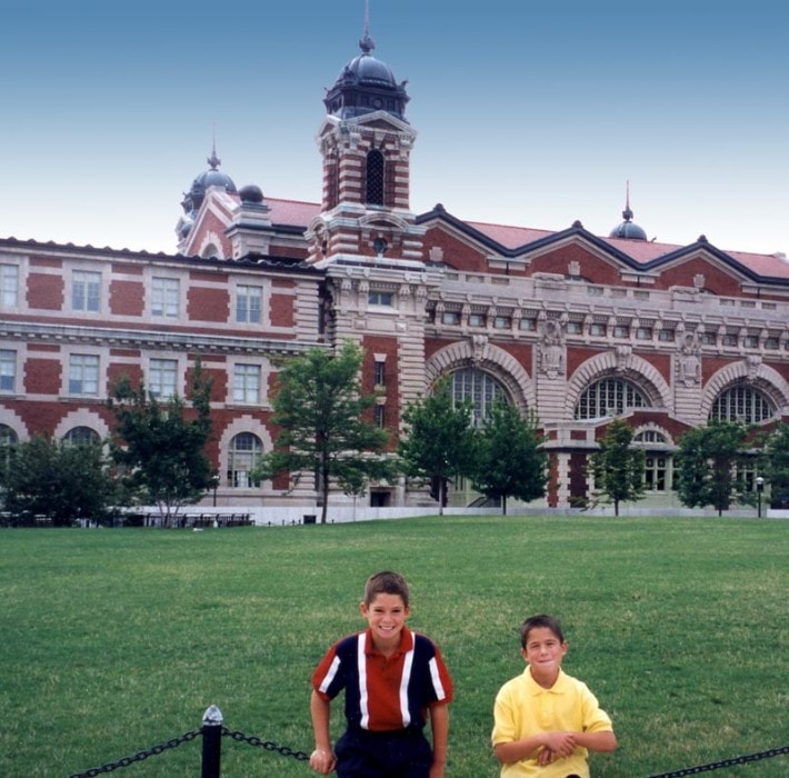 Tommy and Dan on the lawn in front of the Ellis Island immigration building