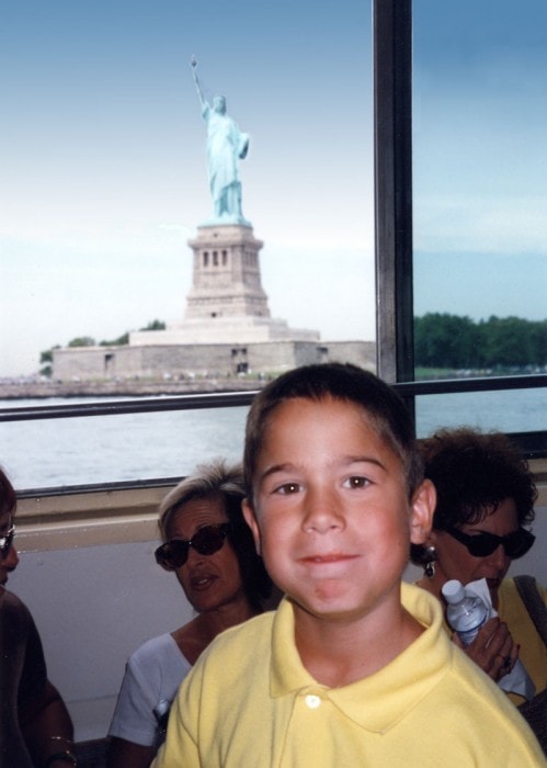 Tommy on the ferry with the Statue of Liberty behind him, 1997