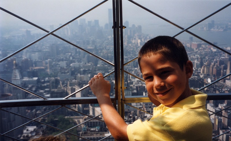Tommy at the Empire State Building observation deck with the Manhattan skyline, 1997