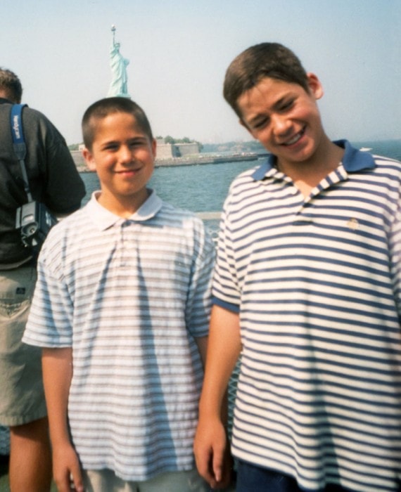 Tommy and Dan on the ferry with the Statue of Liberty behind them, 1999