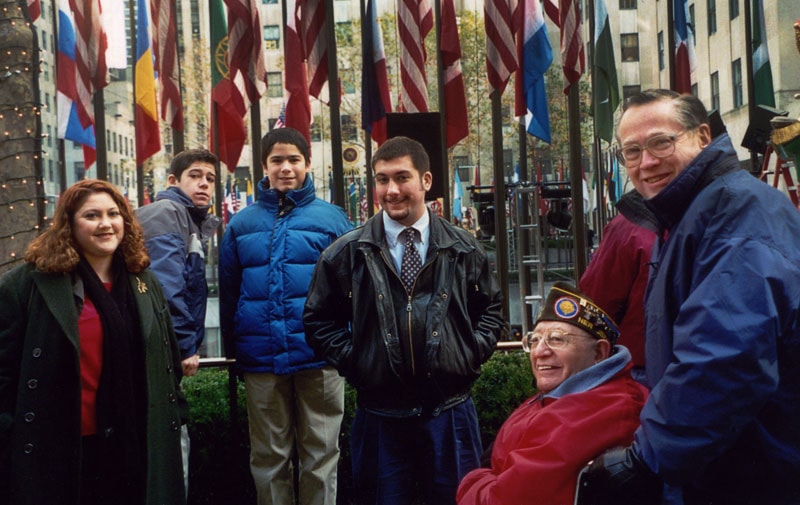 Family group at Rockefeller Center with international flags, 2001