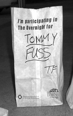 Luminary bag reading "I'm participating in The Overnight for Tommy Fuss TF"