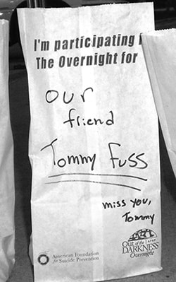 Luminary bag reading "Our friend Tommy Fuss — miss you, Tommy"