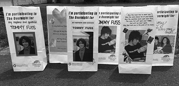 A line of luminary bags dedicated to Tommy Fuss at the Out of the Darkness Overnight walk